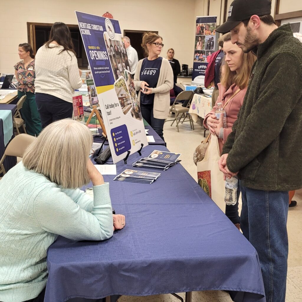 Family engaging with woman behind table