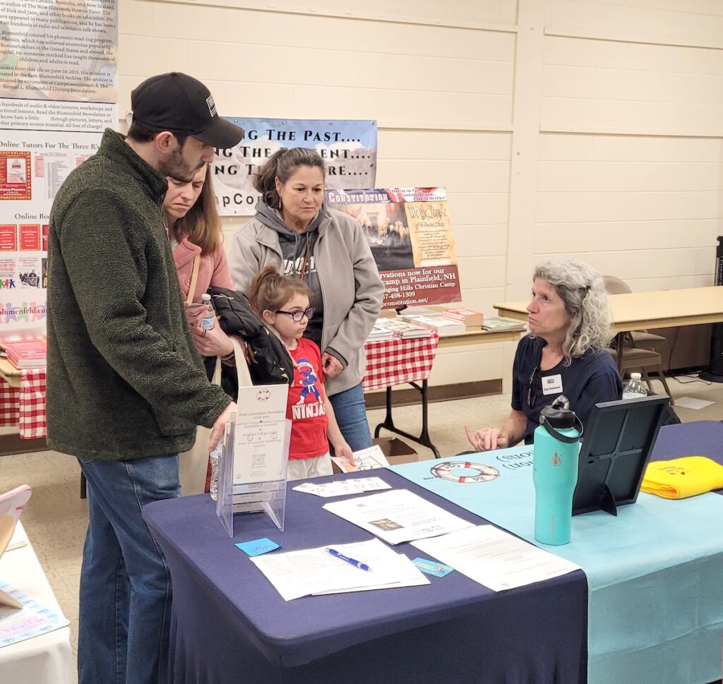 Family engaging with woman in front of table