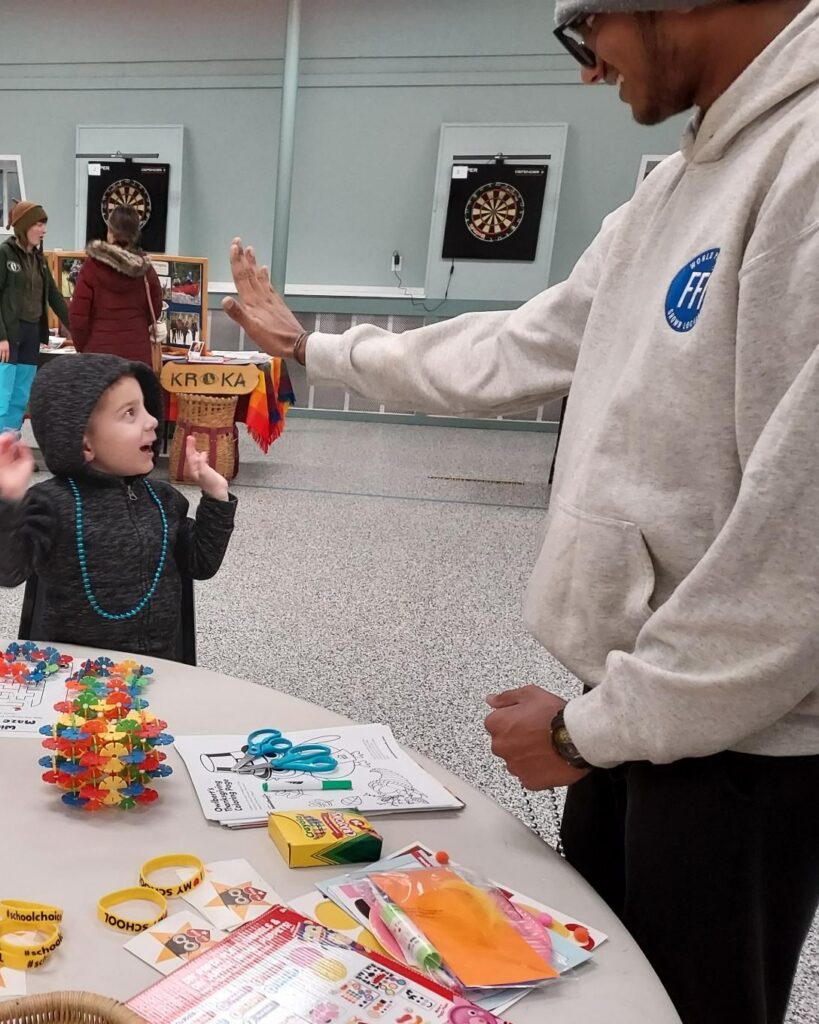 Young boy and older boy doing a "high-5"