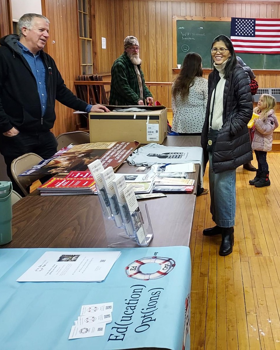 Two people smiling at an education fair