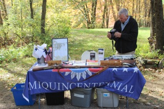 Hal Shurtleff stands behind a display with a blue patriotic banner at EdOpt’s 2026 Donor and Volunteer Appreciation Gathering.