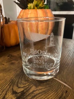 An etched glass commemorates Hal Shurtleff as the inaugural 2026 EdOpt Beacon Award recipient.